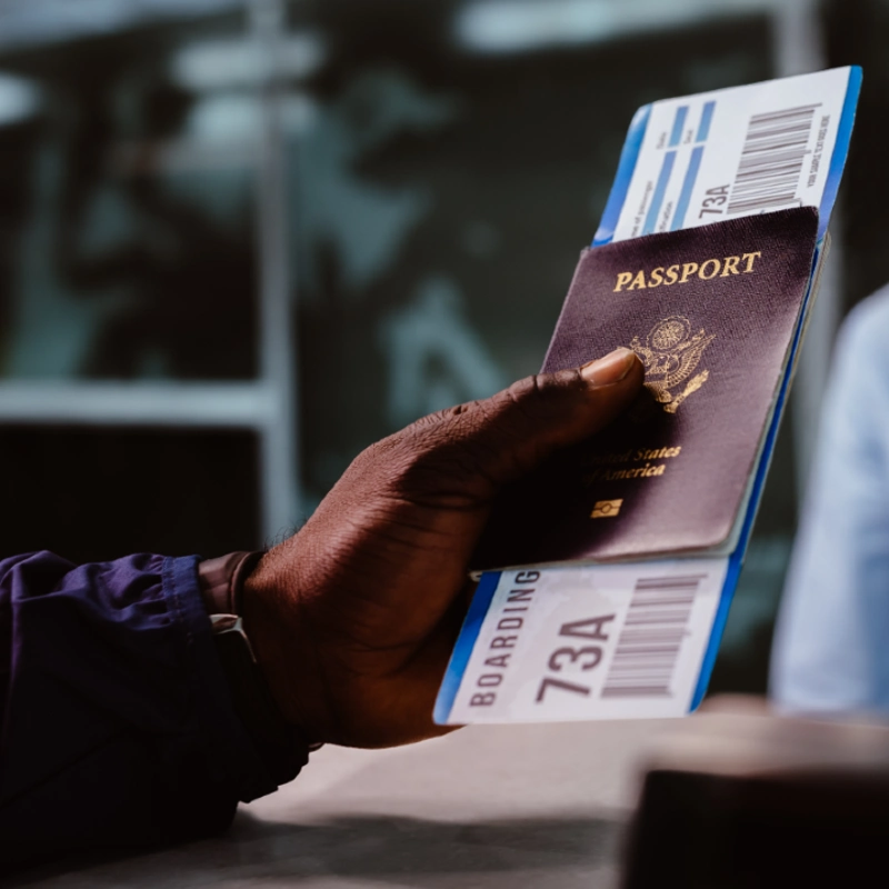 Man holding passport and ticket