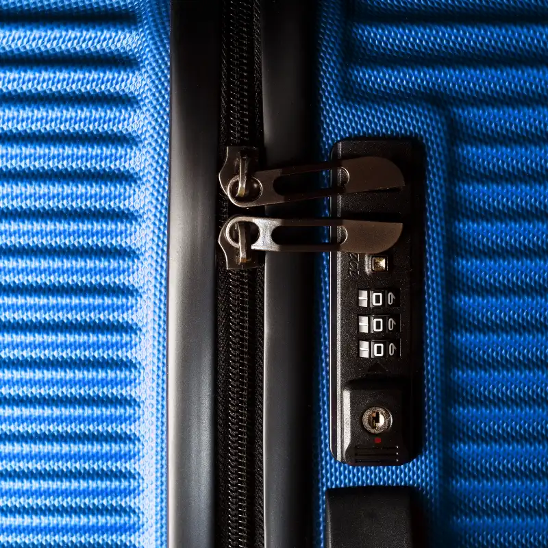 Blue suitcase showing zip and lock